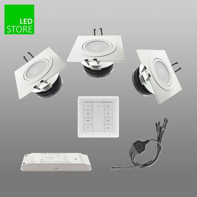 Lampes LED encastrées rondes, interrupteur mural, alimentation et câblage sur fond gris, "LED STORE" en texte vert - les bases de l'éclairage économe en énergie.