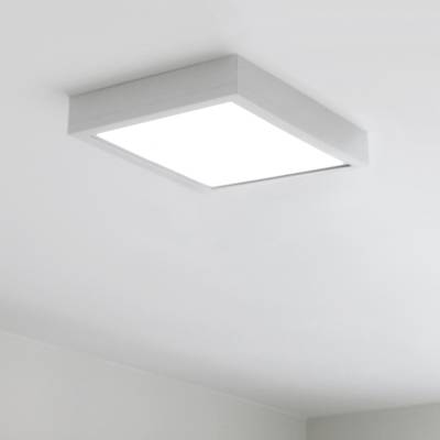 Un plafonnier carré avec une lumière blanche brillante dans une pièce minimaliste peinte en blanc. L'éclairage LED moderne met en valeur n'importe quel espace.