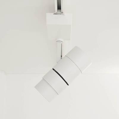 Plafonnier blanc cylindrique moderne aux lignes épurées, installé sur un plafond blanc par une société d'éclairage LED.