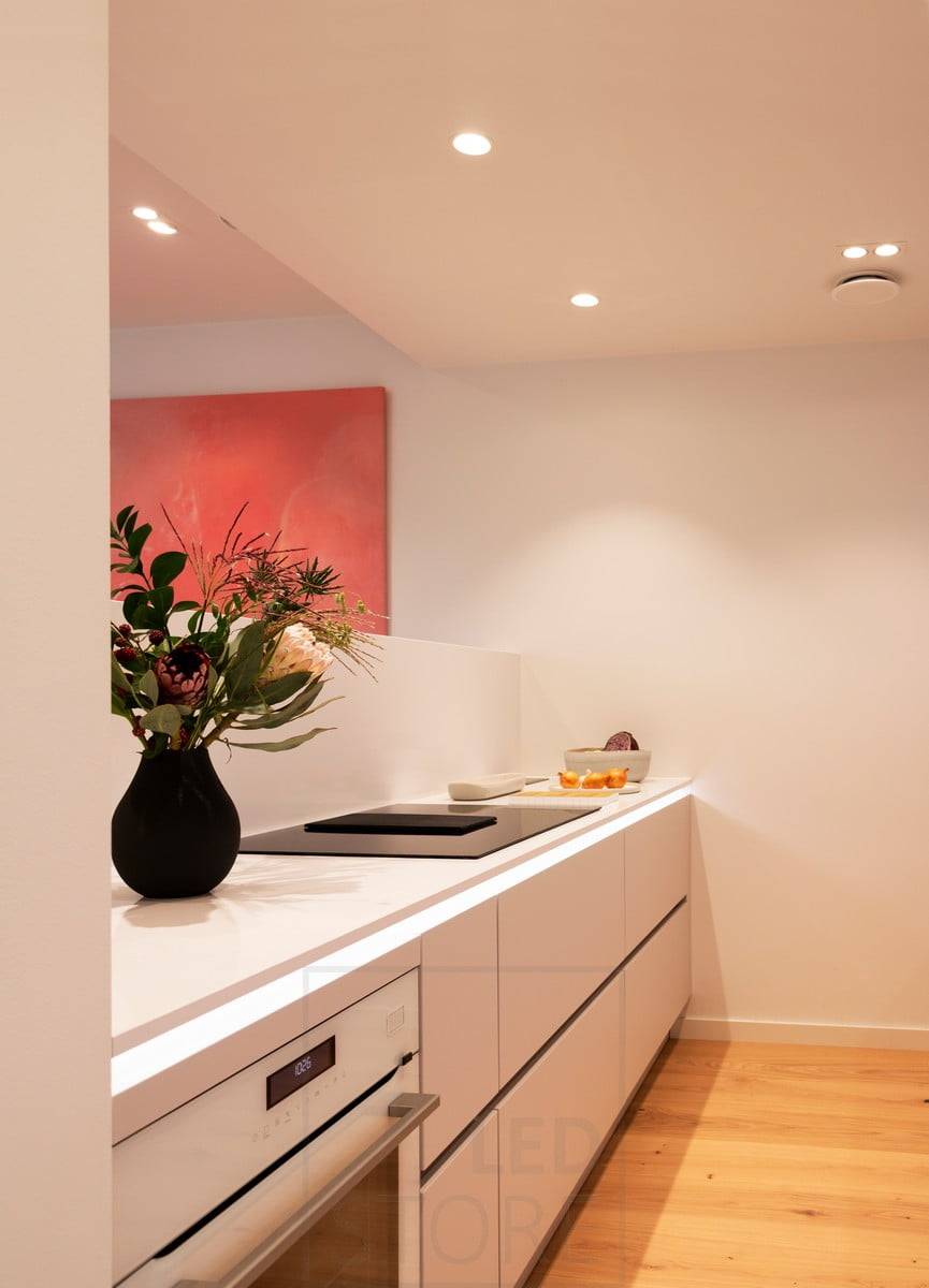 Housing Fair 2020 : un profilé LED au bas du plan de travail de la cuisine éclairant la lumière indirecte. Des spots pour l'éclairage général. Ledstore.fi