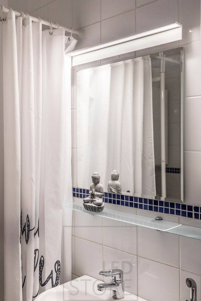 Lampe murale au-dessus du miroir dans la salle de bain. Le luminaire éclaire bien le visage ainsi que le miroir. Ledstore.fi