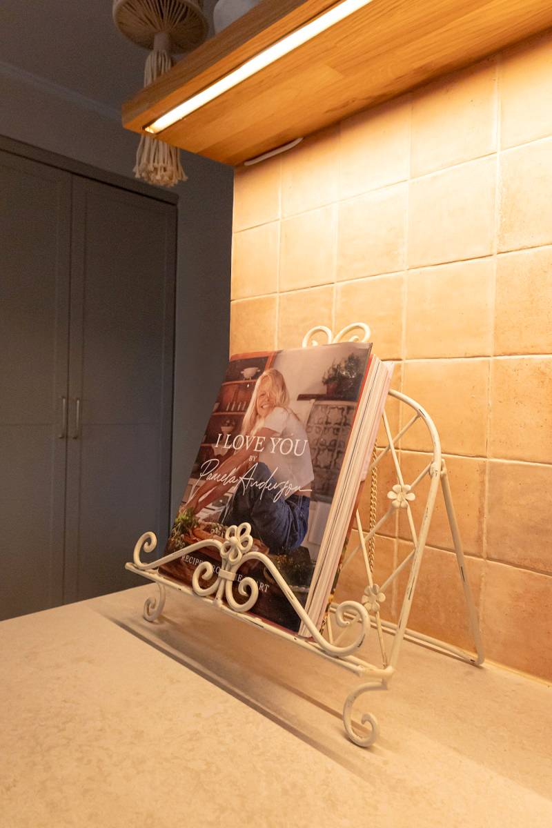 Une bande LED installée sous une étagère éclaire le niveau de la cuisine.