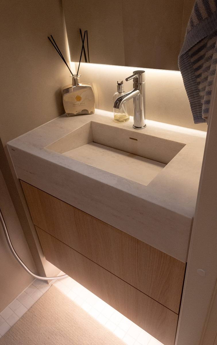 Une bande LED placée derrière le miroir éclaire le plan de lavabo.