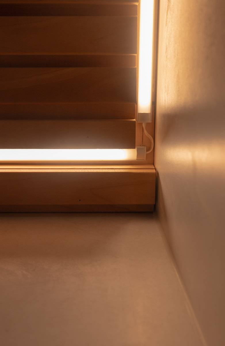 Gros plan sur l'installation d'une bande LED au plafond d'une salle de bains.