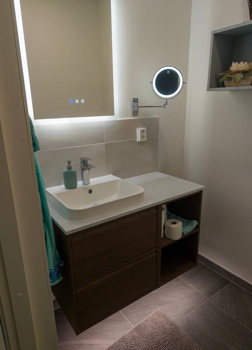 En plus de la bande LED dans la salle de bain, un miroir lumineux et une petite lampe ronde