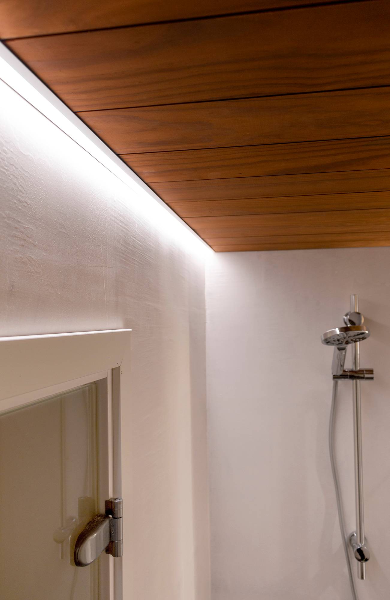 Au ras du plafond, une bande de leds sur le profilé de bordure éclaire la douche. Ledstore.fi
