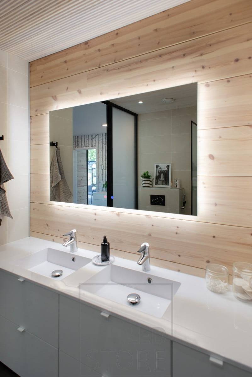 Le grand miroir lumineux HALO fournit un éclairage efficace à travers le mur et ajoute de l'espace à la salle de bains. Ledstore.fi