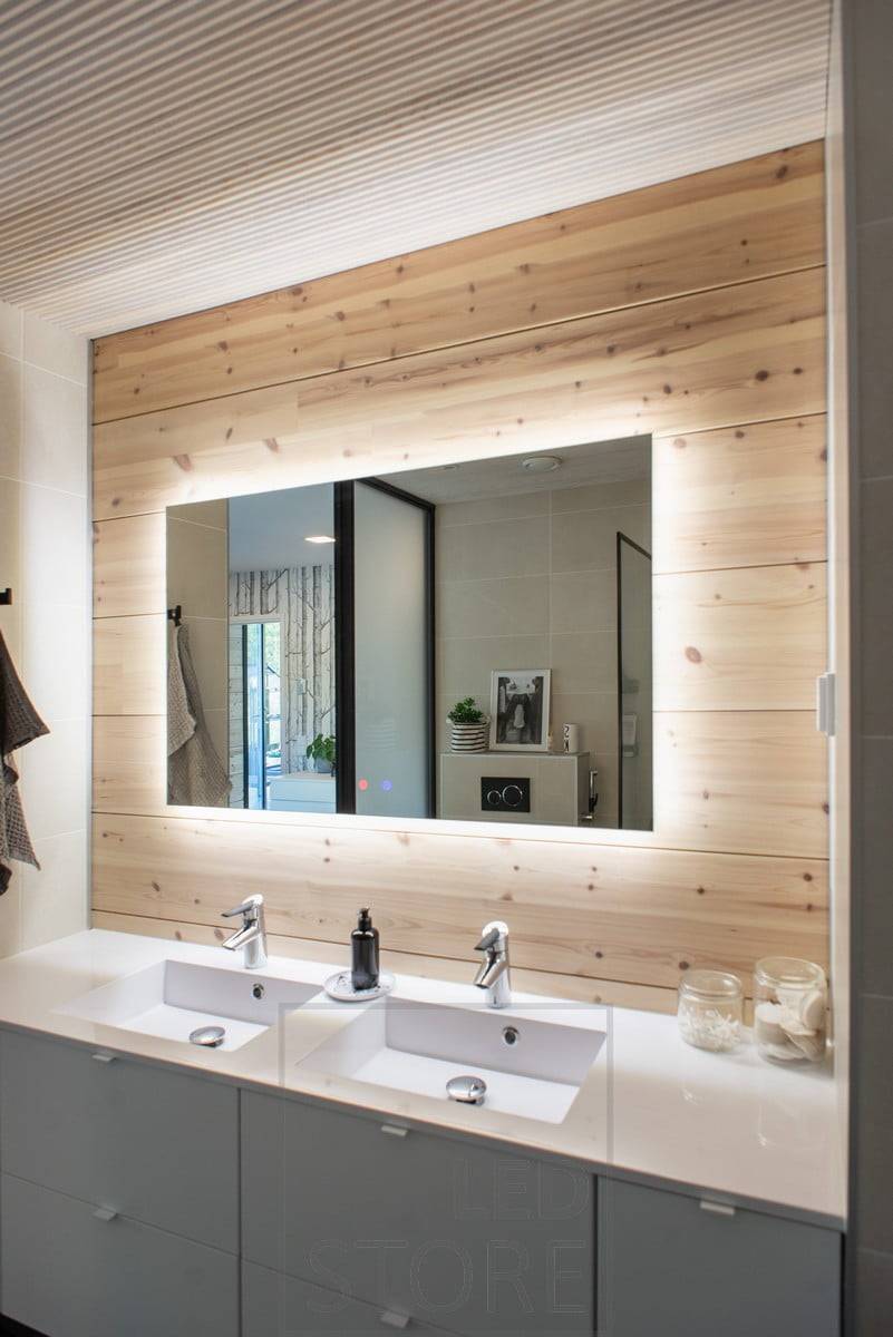 Le grand miroir lumineux HALO fournit un éclairage efficace à travers le mur et ajoute de l'espace à la salle de bains. Ledstore.fi