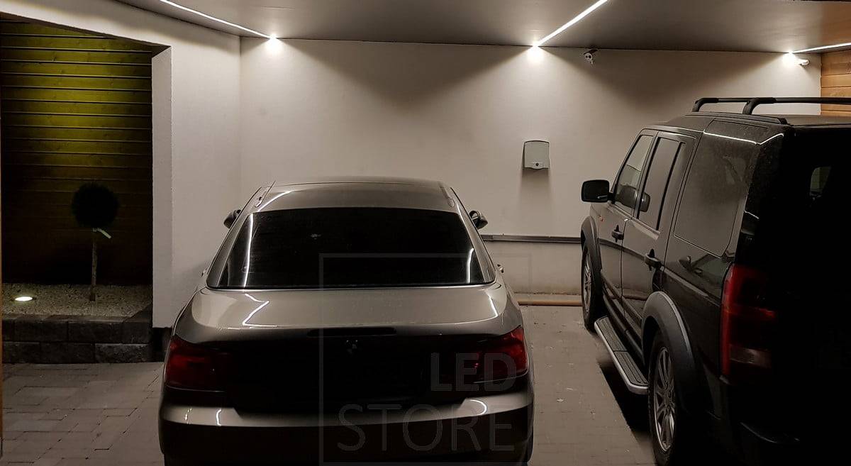 Bande LED pour abri de voiture dans une surface à profil bas. Positionnée de façon à ce que la lumière ne s'arrête pas au toit de la voiture, mais illumine les côtés de la voiture. Ledstore.fi