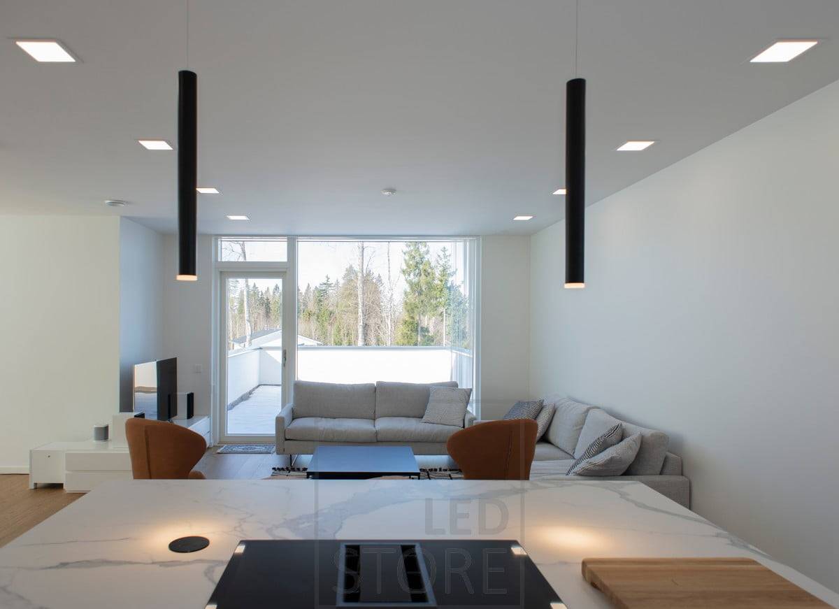 Lampes cheminées en haut de l'îlot et lampes panneaux au plafond. Ledstore.fi