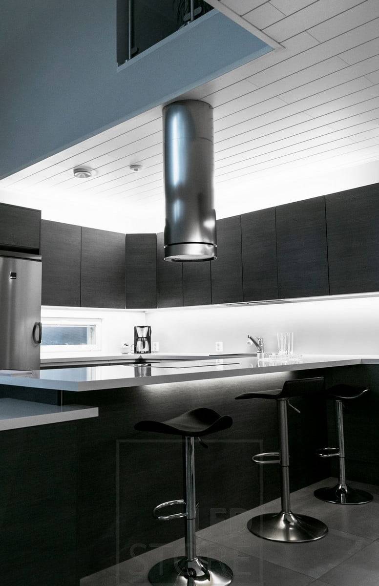 Dans la cuisine, des bandes LED sur le dessus des armoires et sur le plan de travail. Ledstore.fi