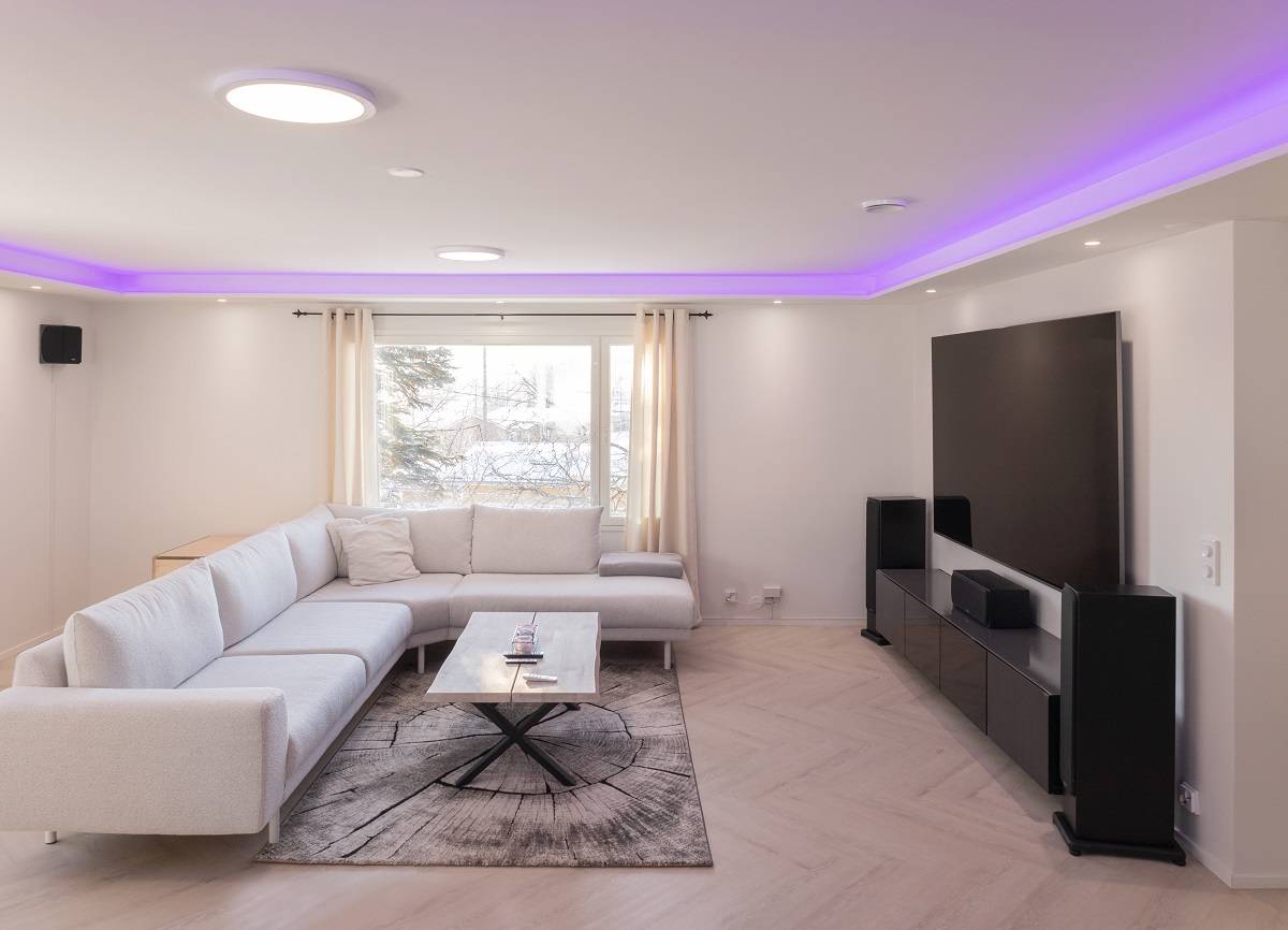 Living room RGB+CCT led strip lighting in low light.