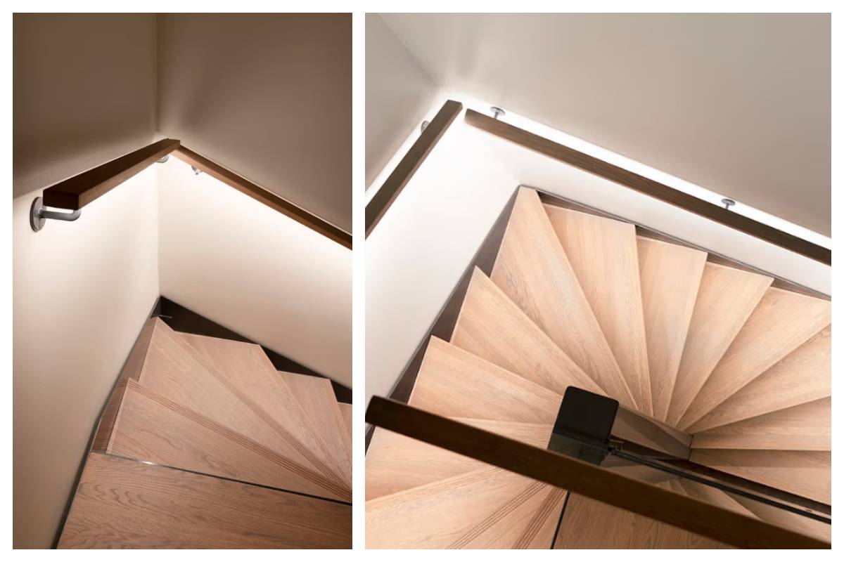 Des escaliers en bois avec des rampes en métal, vus d'en haut et de côté - un système d'éclairage moderne de LedStore.fi met en valeur ce détail élégant dans la maison de la famille Kaitamäki à Espoo.