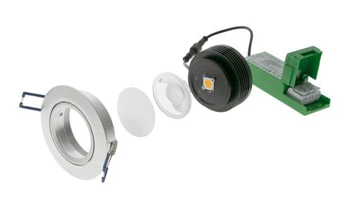 Vue éclatée du downlight LED : corps, lentille, module LED et transformateur vert.